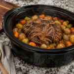 Finished Crockpot pot roast with potatoes, carrots, onions and gravy