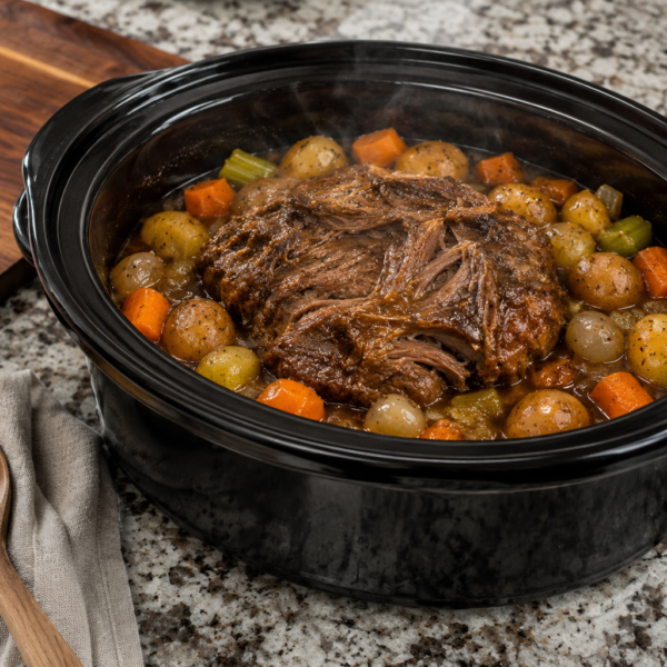 Finished Crockpot pot roast with potatoes, carrots, onions and gravy