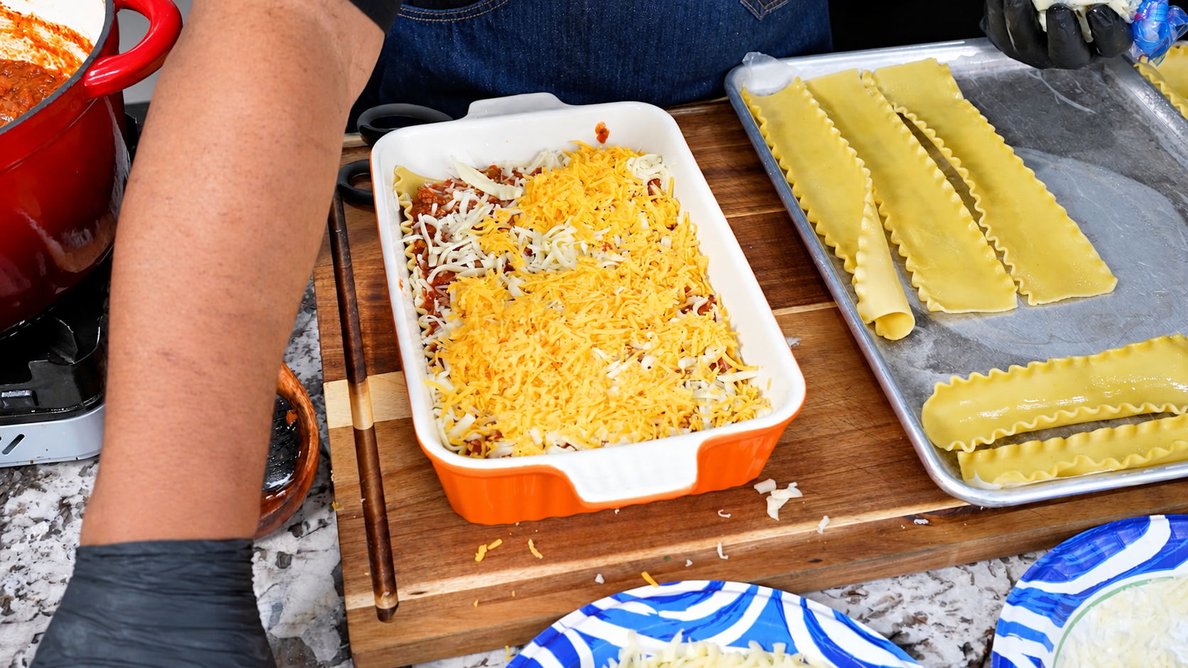 Shredded cheese sprinkled over the lasagna meat sauce layer.