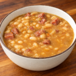 A bowl of white bean and ham soup.