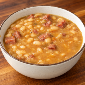 A bowl of white bean and ham soup.