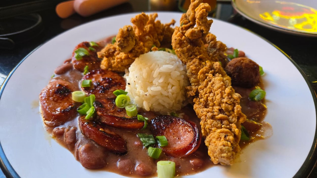 White rice with red beans, browned sausage, golden breaded fried pieces and chopped green onions.