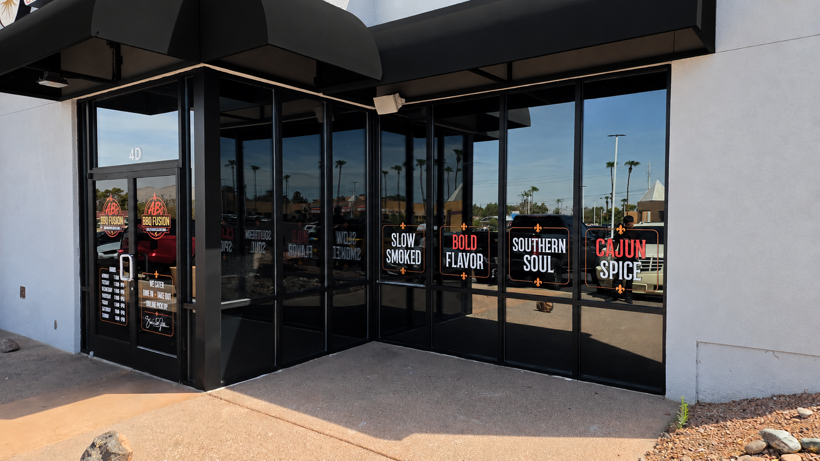 AB’s BBQ Fusion entrance with black awnings and branded windows